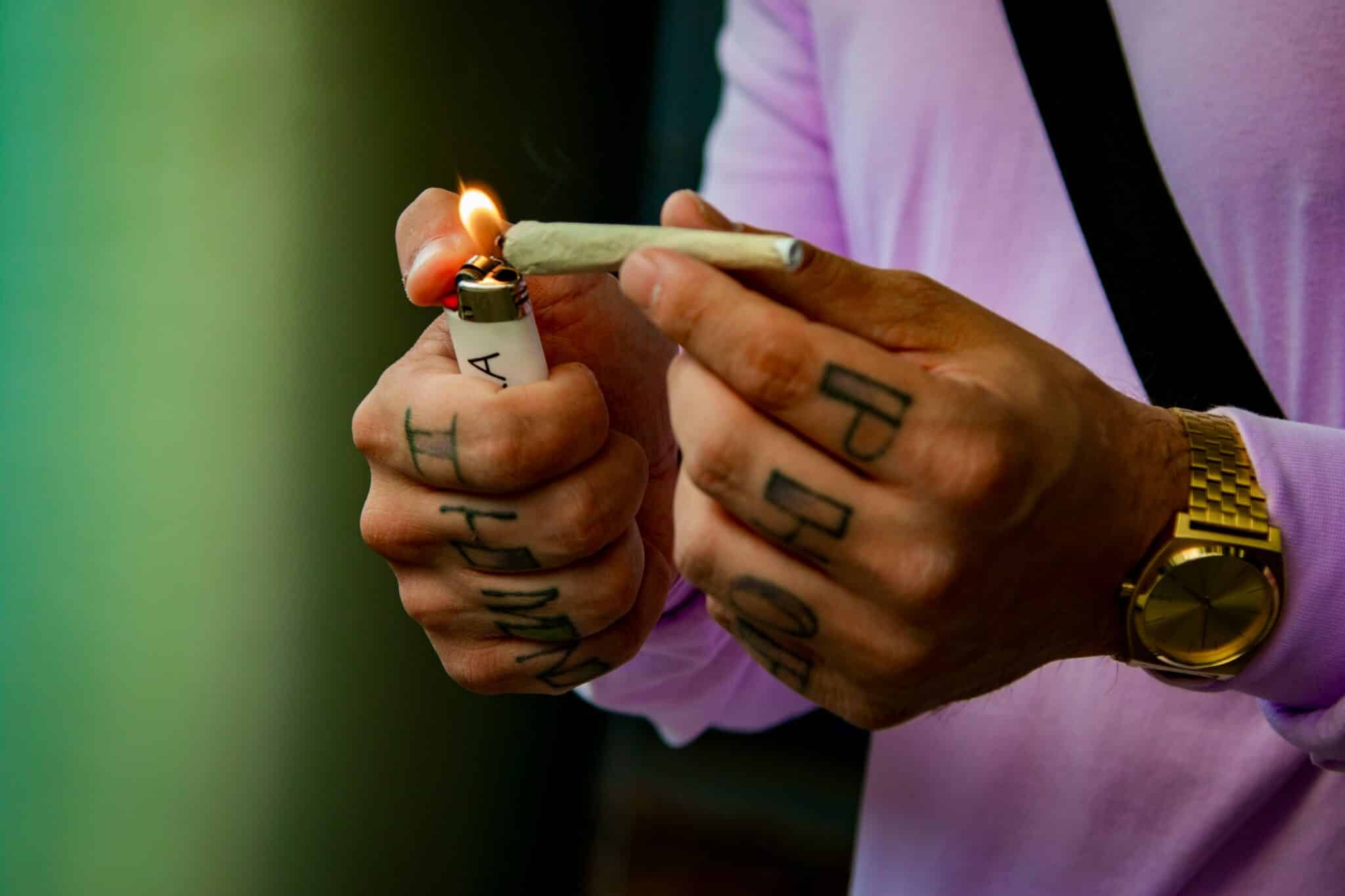 Main allumant un joint de fleur HPC BUDDY BOO, CBD qui défonce sans THC